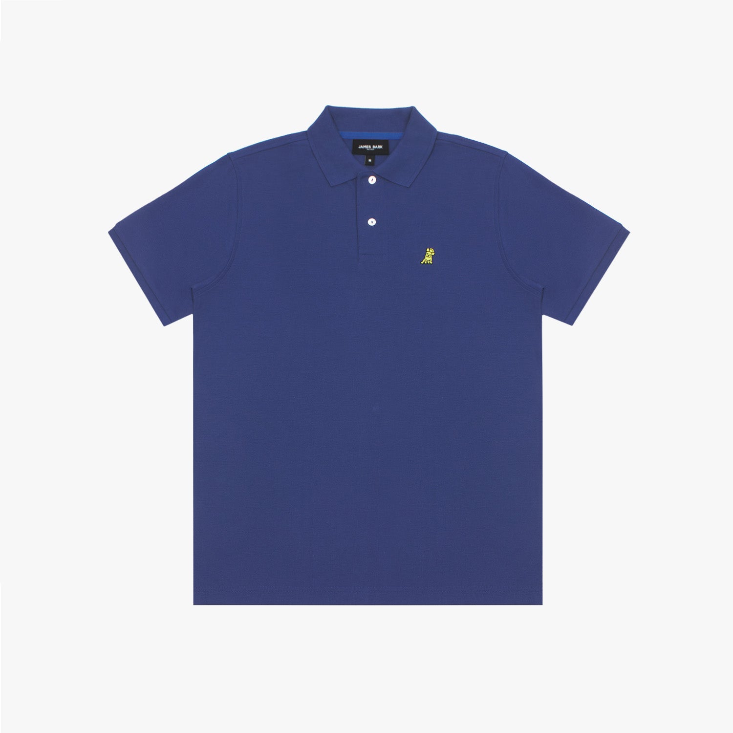 A full-body image of a male model wearing the James Bark royal blue polo shirt paired with beige pants and sneakers, standing in a casual pose against a white background