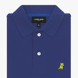 A folded detail of the polo shirt’s collar and buttons, zoomed in to showcase the embroidery and fabric quality