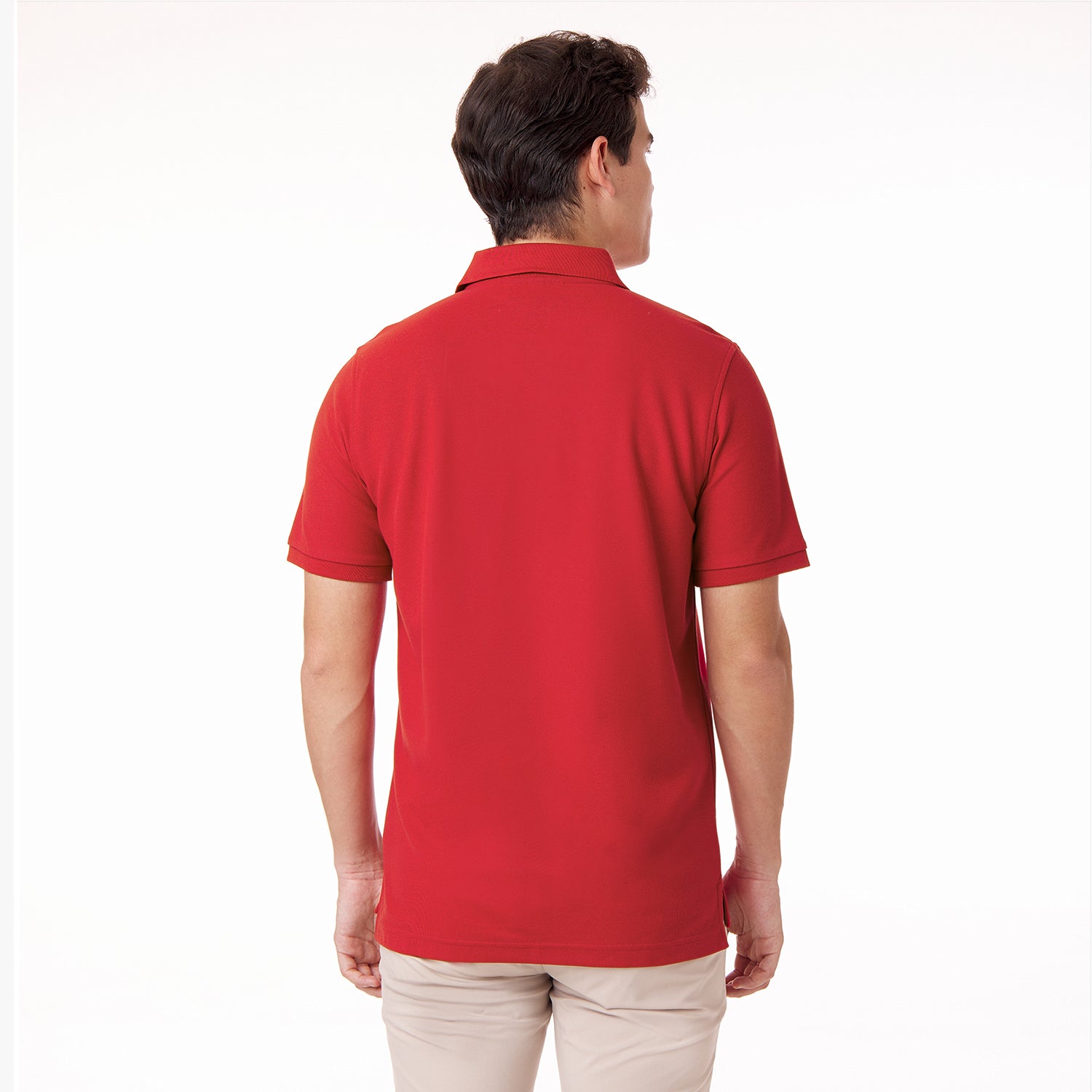 Back view of a male model wearing a red polo shirt and tan pants