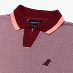 A detailed close-up of a striped polo shirt with a fine burgundy and white micro-stripe pattern. The ribbed collar is a rich burgundy color, accented with a soft pink stripe along the edges for contrast. The open placket design gives it a modern and casual feel. A subtle, embossed dog logo in a matching burgundy tone is placed on the left chest, adding a refined yet minimalistic touch. The fabric appears textured and breathable, ideal for a polished yet relaxed look.