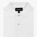 Close-up of the collar and tag of the white polo shirt, focusing on the buttons and fabric details.