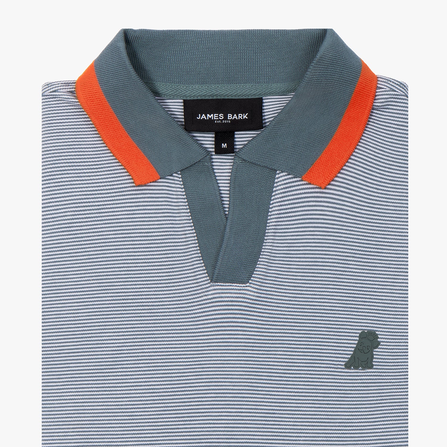 Close-up of a striped polo shirt showcasing a fine blue and white micro-stripe pattern. The ribbed collar is dark green with a contrasting burnt orange stripe on the edge. The shirt features an open placket design without buttons, adding a modern touch. The James Bark brand label is visible inside the collar, along with the size "M." On the left chest, there's a subtle tonal embroidered dog logo, enhancing the premium look of the garment.