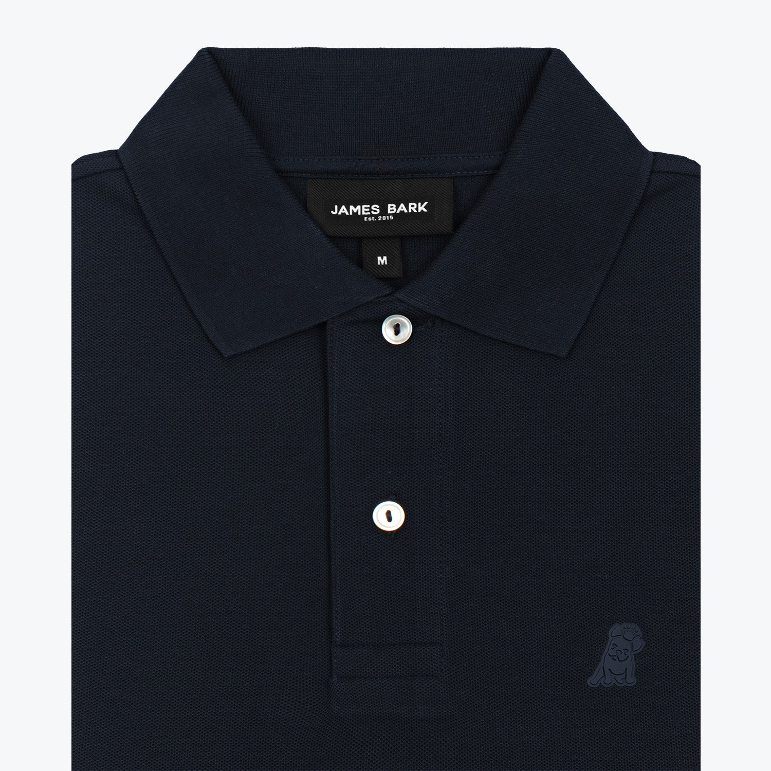 Close-up of the navy blue polo shirt collar and buttons, highlighting the fabric texture and branding detail.