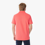 Back picture of a man wearing a coral polo shirt on a white background