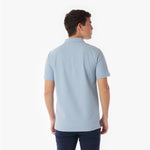 Back picture of a man wearing a light blue polo shirt on a white background