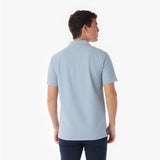Back picture of a man wearing a light blue polo shirt on a white background