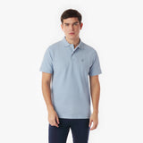 Man wearing a light blue polo shirt on a white background