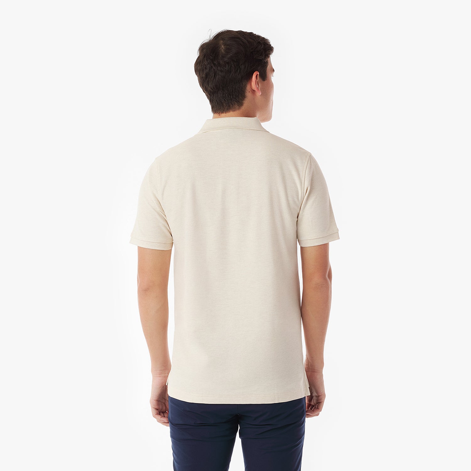 Back picture of a man wearing a beige polo shirt on a white background