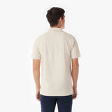 Back picture of a man wearing a beige polo shirt on a white background