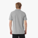 Man wearing a gray polo shirt on a white background