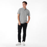Full body picture of a man wearing a gray polo shirt and black pants on a white background