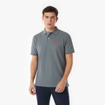 Man wearing a gray polo shirt with a red logo on a white background