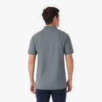 Back picture of a man wearing a gray polo shirt on a white background