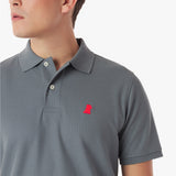 Close-up of a gray polo shirt with a red logo on a white background