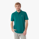 Man wearing a teal polo shirt with a small logo on a white background