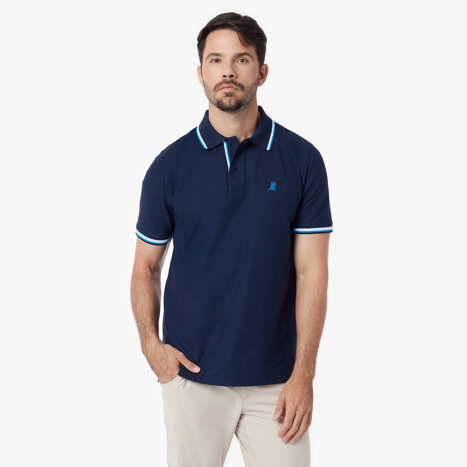 Man wearing a navy blue polo shirt with a small logo on a white background