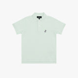 A light mint green polo shirt for kids, featuring a small embroidered logo on the left chest and a black brand label on the collar