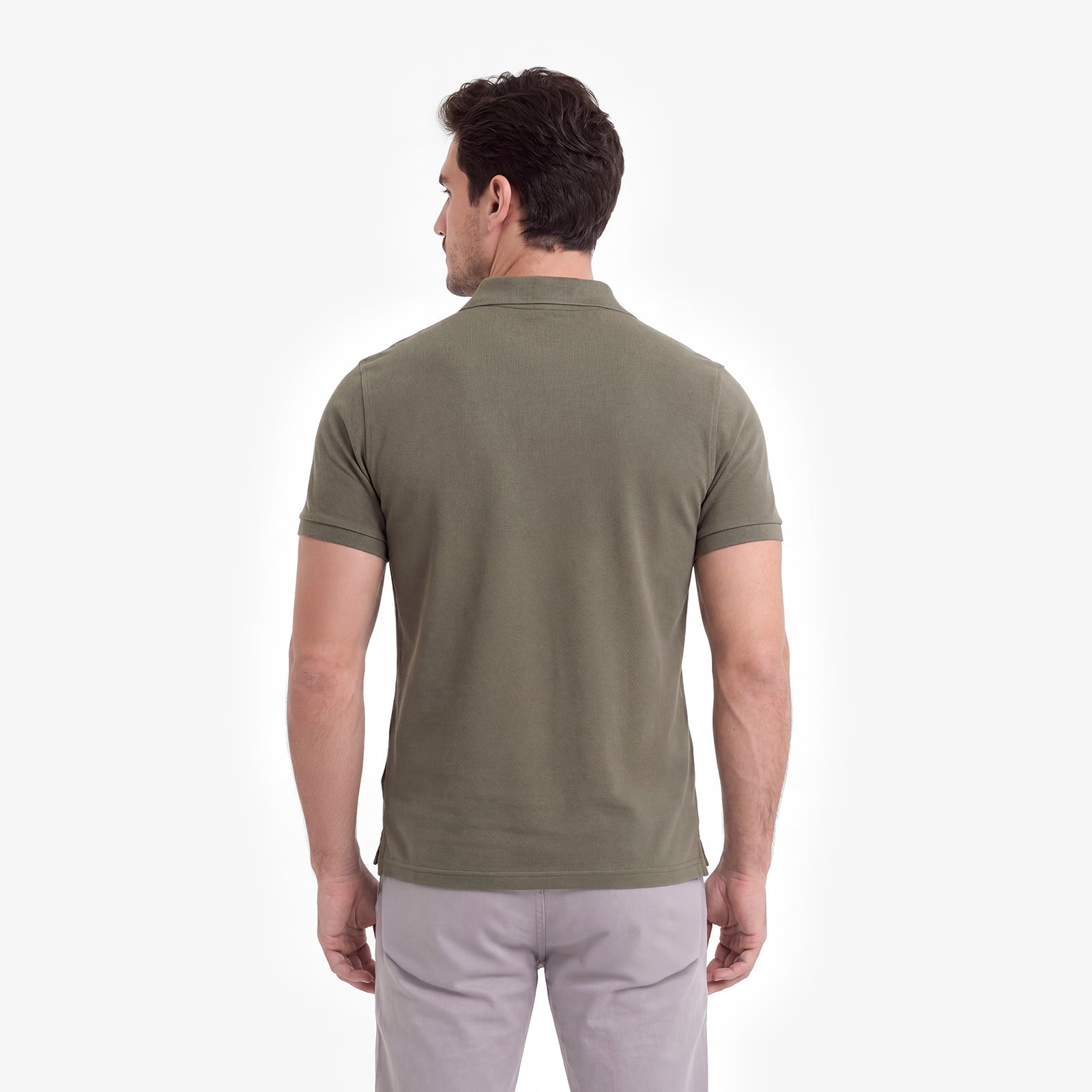 Man wearing a green polo shirt on a white background