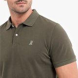 Green polo shirt with a small logo on a white background