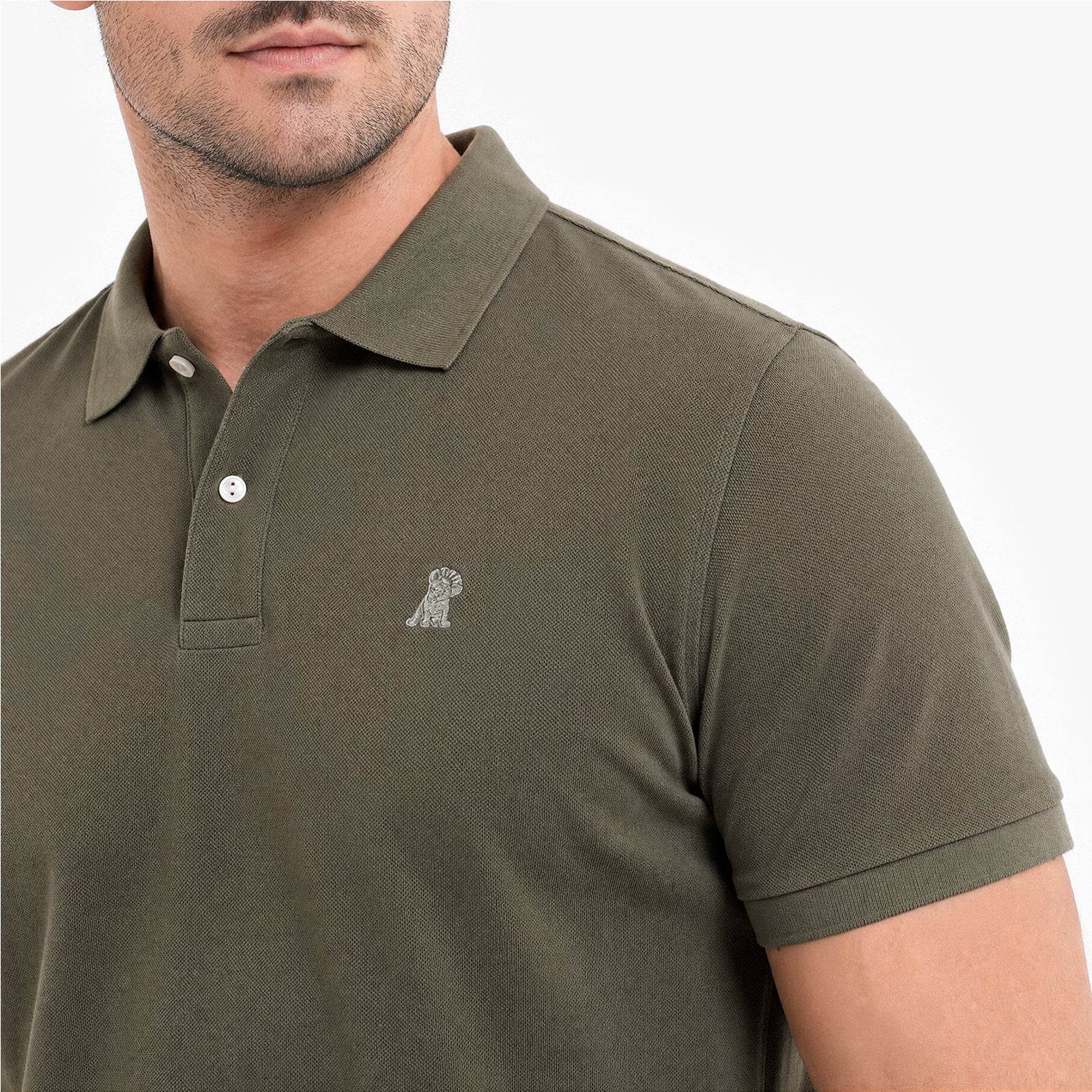 Green polo shirt with a small logo on a white background
