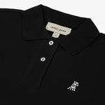 Close-up of the chest area, highlighting the embroidered logo and button detail on the black polo shirt.