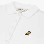 Close-up of the chest, highlighting the collar and black logo on the white polo shirt.