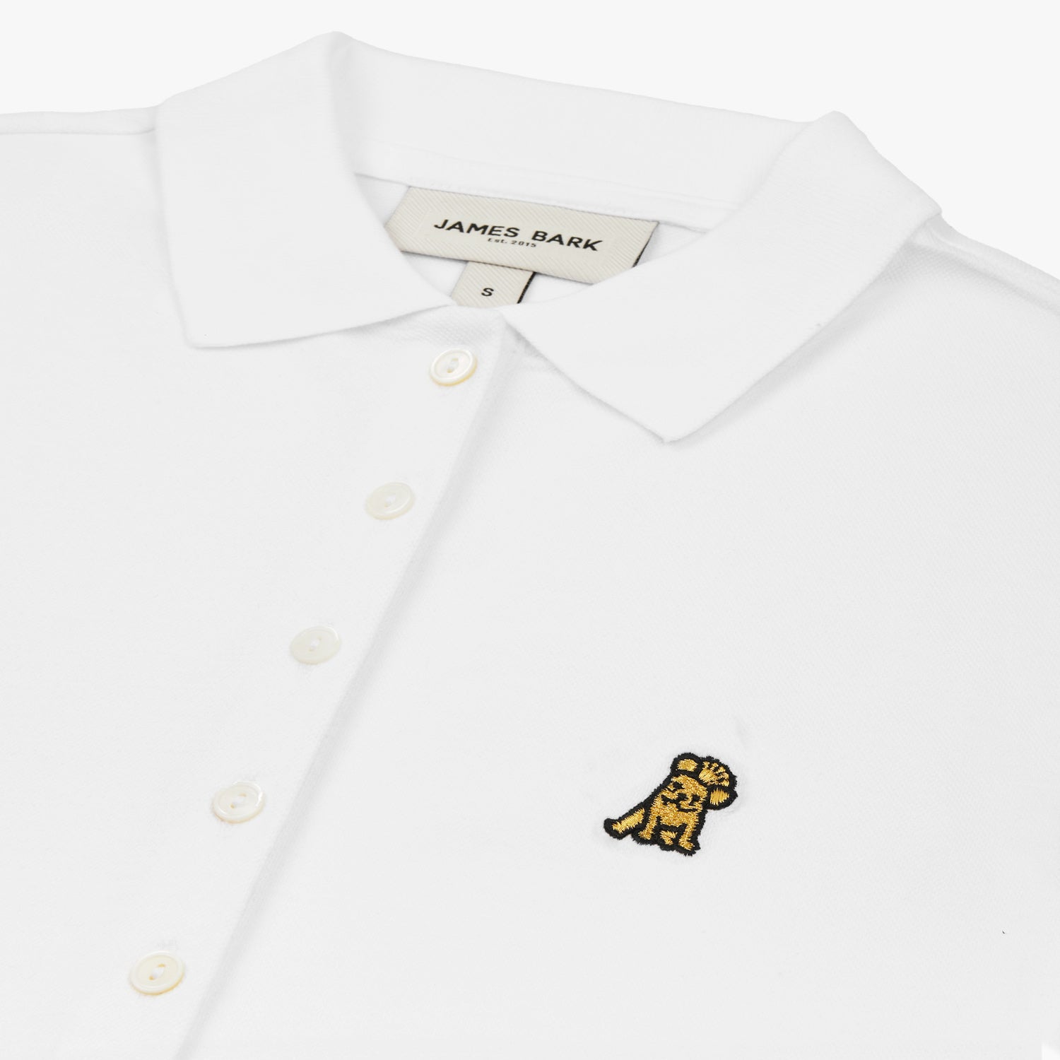 Close-up of the chest, highlighting the collar and black logo on the white polo shirt.