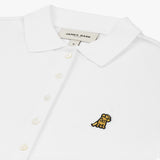 Close-up of the chest, highlighting the collar and black logo on the white polo shirt.