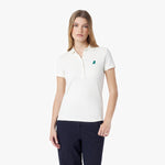 Woman wearing a white polo shirt with a logo on a white background