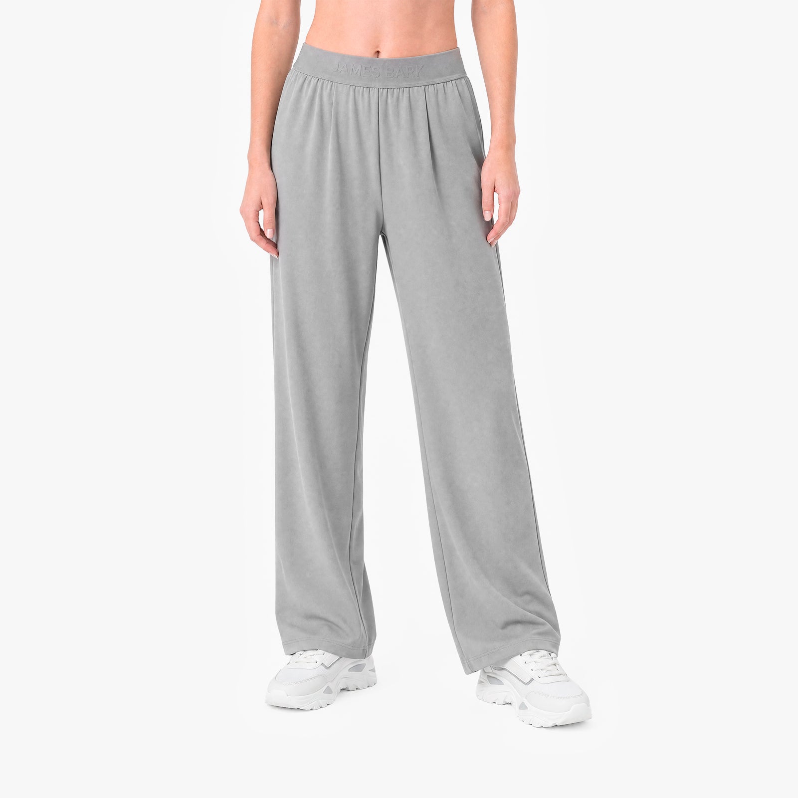 Person wearing gray sweatpants on a white background