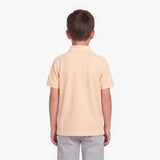 A child viewed from the back wearing a polo shirt in a pale peach-beige color
