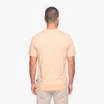 Man wearing a beige t-shirt on a white background