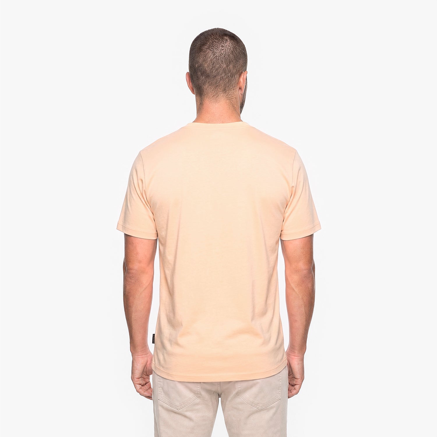 Man wearing a beige t-shirt on a white background