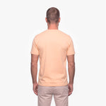 Man wearing a beige t-shirt on a white background