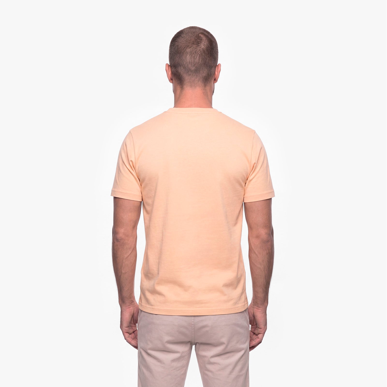 Man wearing a beige t-shirt on a white background