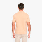 Man wearing a beige polo shirt on a white background