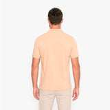 Man wearing a beige polo shirt on a white background