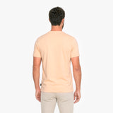 Man wearing a light peach T-shirt and beige pants 