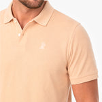 Beige polo shirt with a small logo on a white background