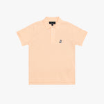 A light peach-pink polo shirt for kids, featuring a small navy embroidered dog logo on the left chest, set against a plain white background.
