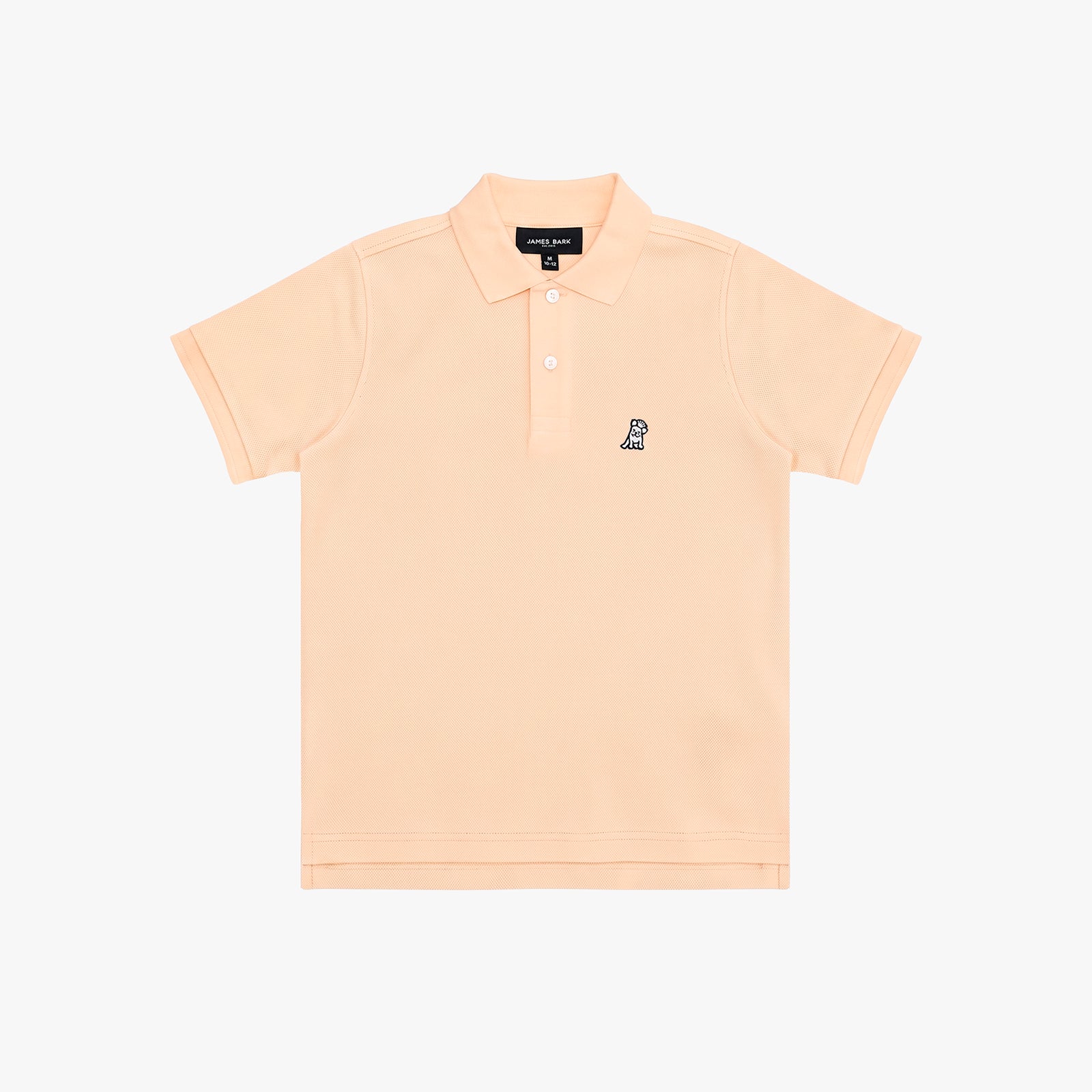 A light peach-pink polo shirt for kids, featuring a small navy embroidered dog logo on the left chest, set against a plain white background.