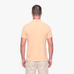 Man wearing a beige polo shirt on a white background