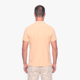 Man wearing a beige polo shirt on a white background