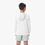 Back picture of a child wearing a white hooded rashguard with 'Beach Club' text and light-colored shorts on a white background