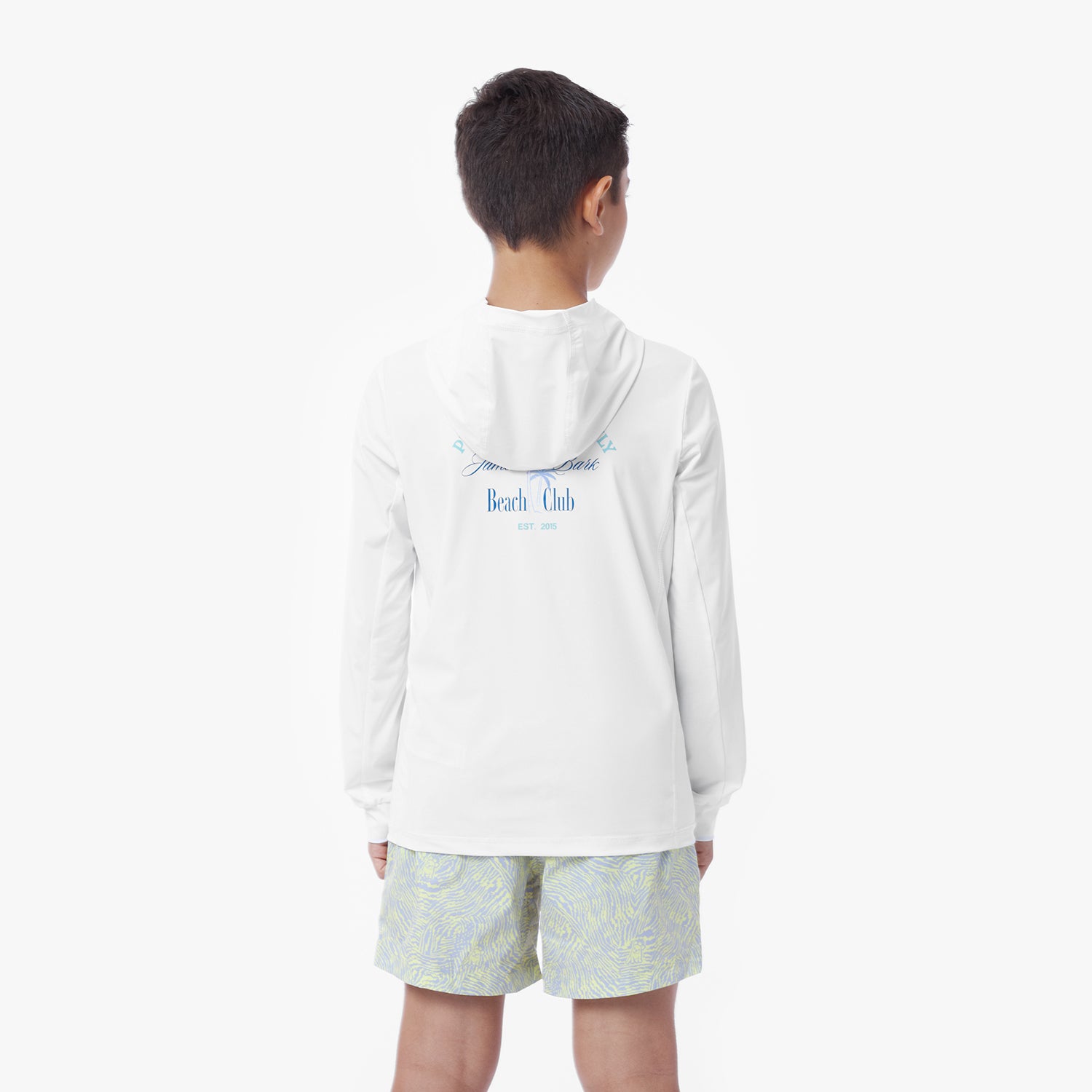 Back picture of a child wearing a white hooded rashguard with 'Beach Club' text and light-colored shorts on a white background