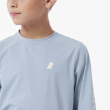Close-up of the light blue long-sleeve rashguard with a small logo on a white background