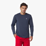 Man wearing a navy long-sleeve rashguard with a logo and red shorts