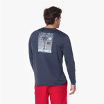 Back view of a man wearing a navy long-sleeve rashguard with a palm tree design on the back