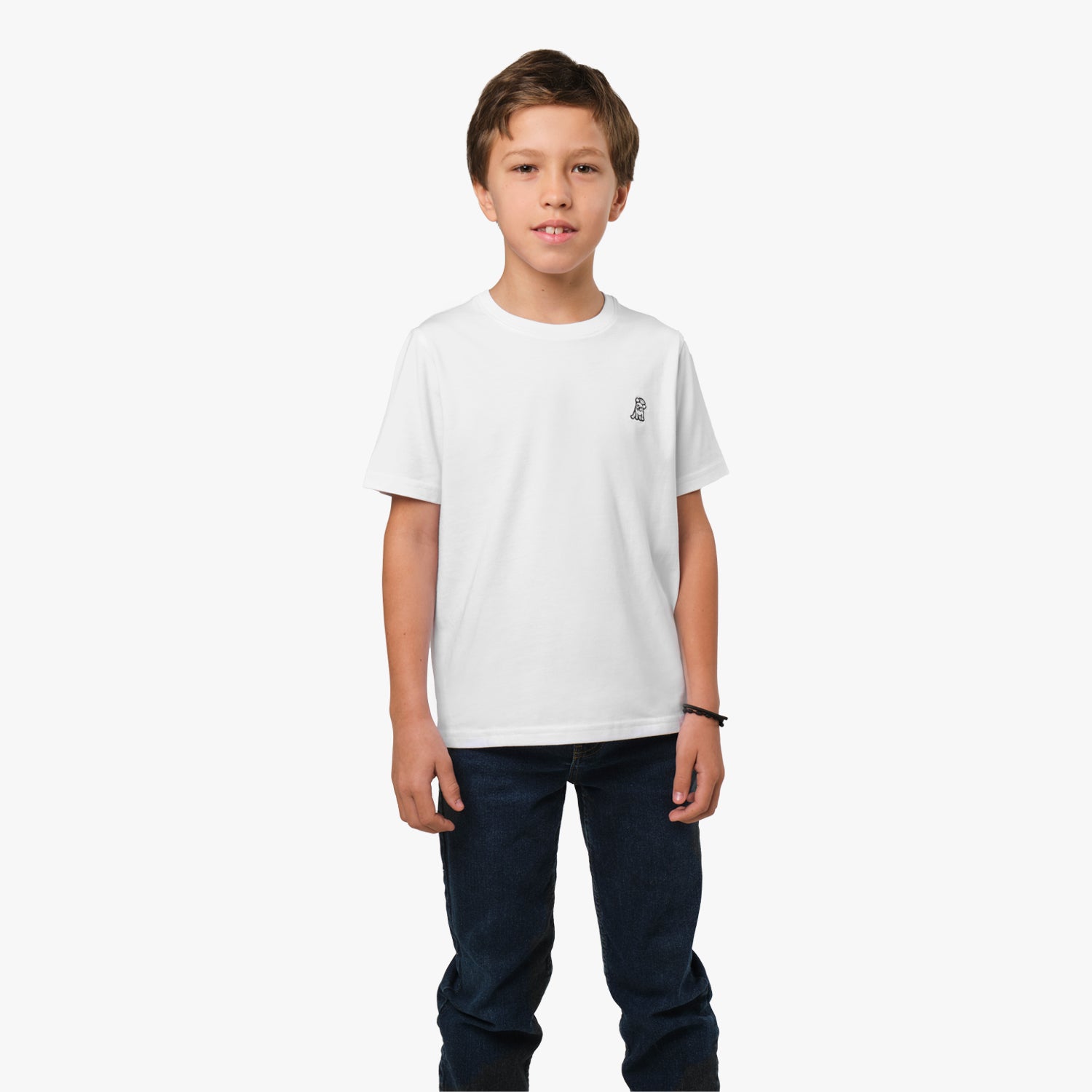 Front view of the boy wearing the white T-shirt, paired with jeans, with a small embroidered logo on the chest.