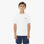 Front view of a young boy wearing a white short-sleeved t-shirt with a yellow logo and navy blue shorts, standing against a white background